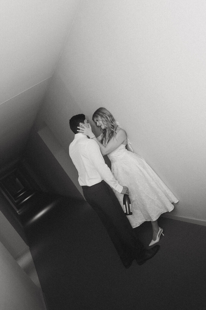 Wife holding her husbands face celebrating their anniversary at a hotel in Virginia