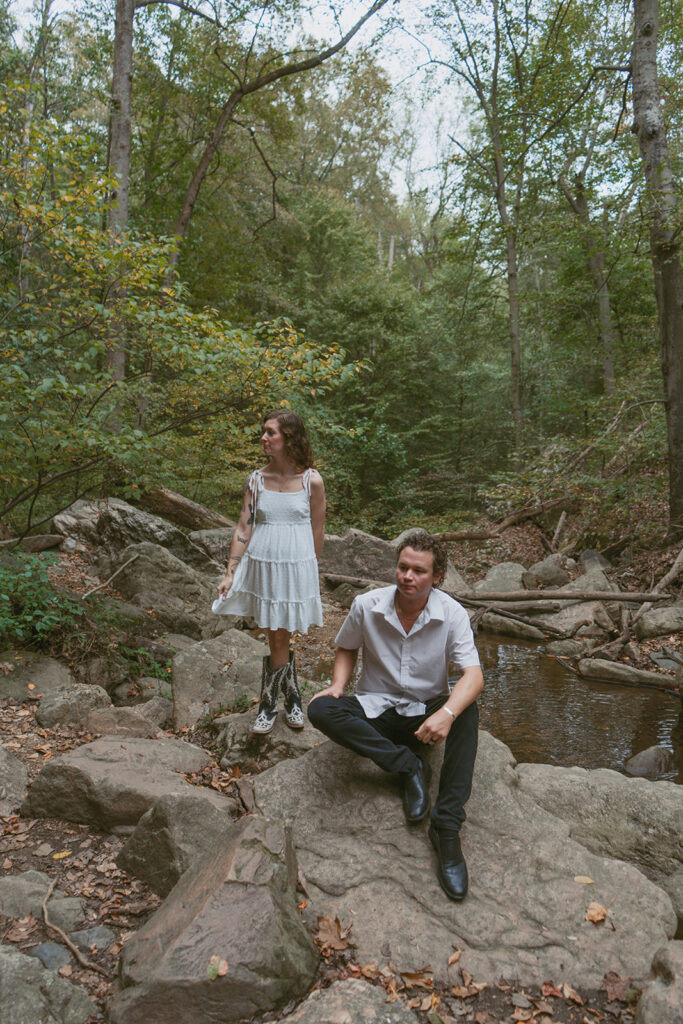 Engaged couple sitting by the river in Patapsco State Park