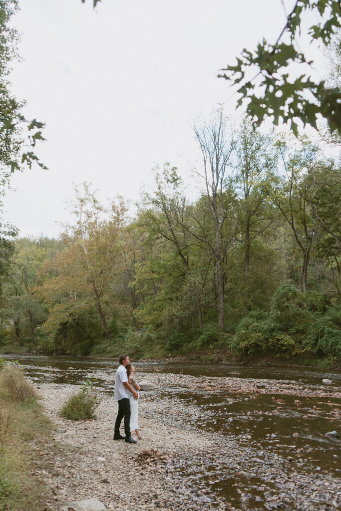 Couple embracing each other by Patapsco Valley State Park River