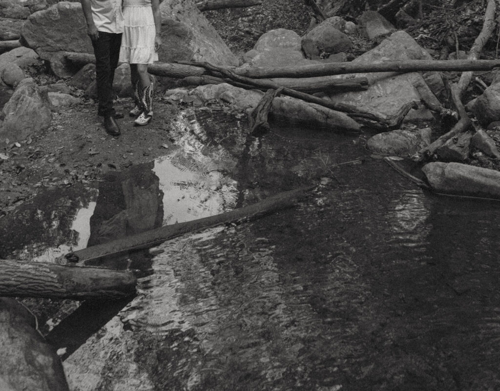 engaged couple standing by a river in Maryland