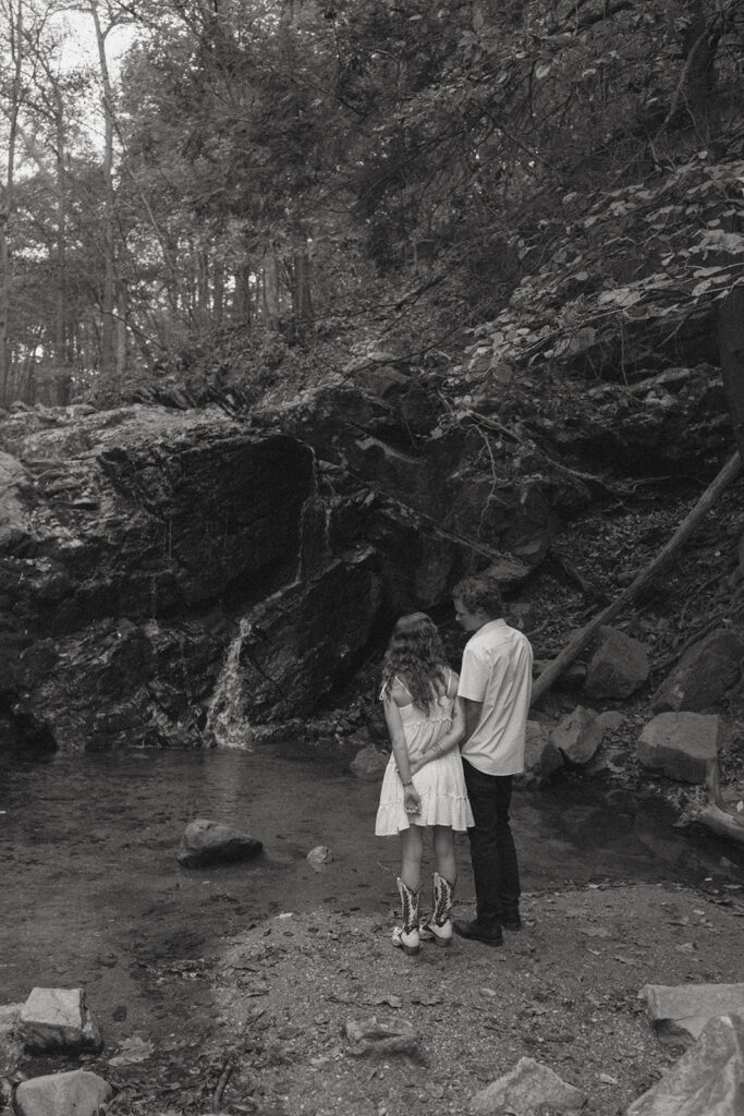 Engaged couple by a waterfall in Maryland